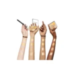 Three hands display various shades of concealer from the Dior Backstage Glow Face Palette - 003 Pure Gold.