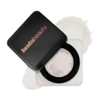 Huda Beauty Easy Bake Loose Powder in a black container, labeled "Sugar Cookie," 20g for baking and setting makeup.