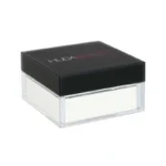 A white powder compact inside a sleek black box, labeled HUDA BEAUTY Easy Bake Loose Powder in Sugar Cookie shade.