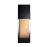 Huda Beauty Faux Filter liquid foundation in light beige shade, Cashew 140G, displayed in a sleek bottle